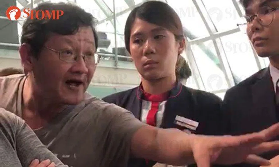 Frustrated Jetstar passengers shout at airport staff after being stranded at Bangkok airport