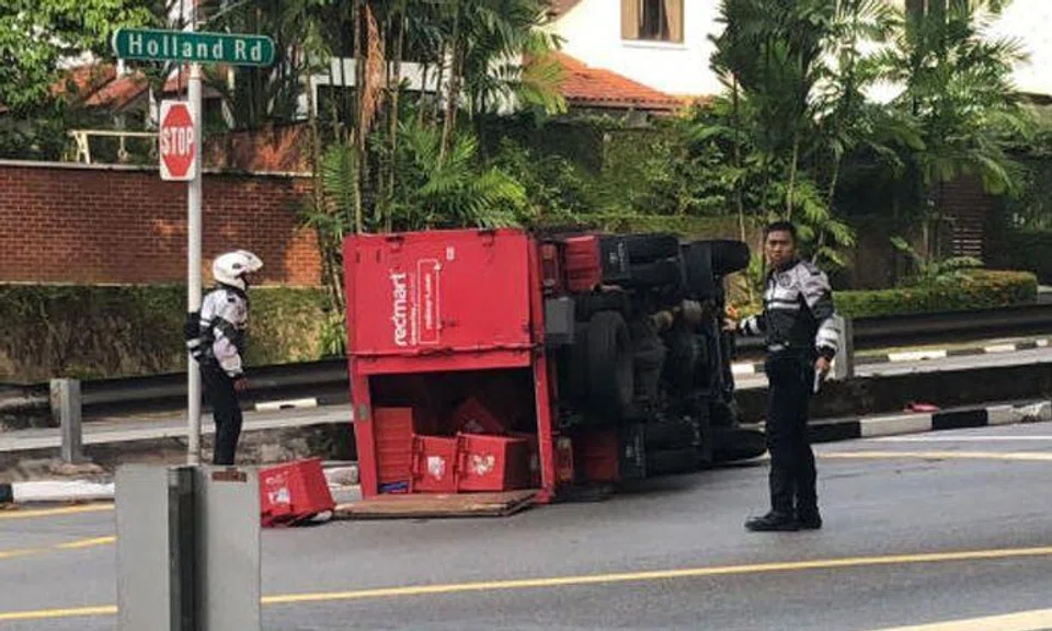 Driver injured after RedMart lorry flips on its side in Holland Road accident