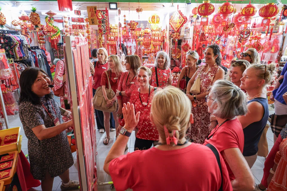 Ms Diana Chua (left) with members from the American Women's Association at Chinatown Complex during a guided heritage tour on Feb 13. ST PHOTO: BRIAN TEO