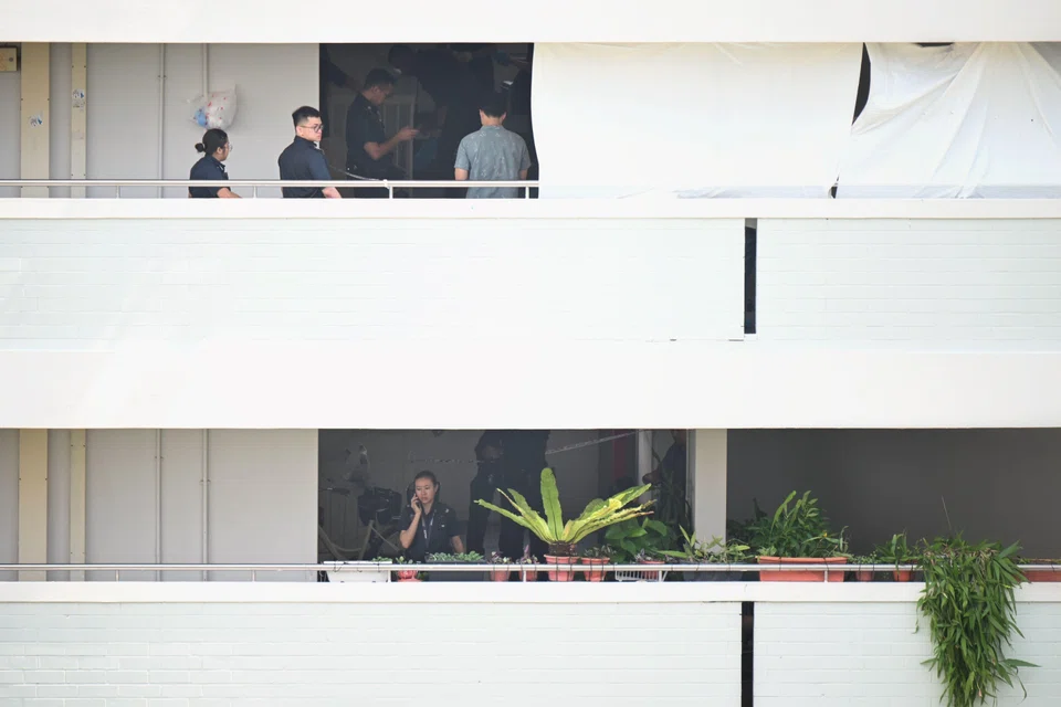 Police officers at Block 323 Yishun Central after the fatal knife attack on Sept 24.
