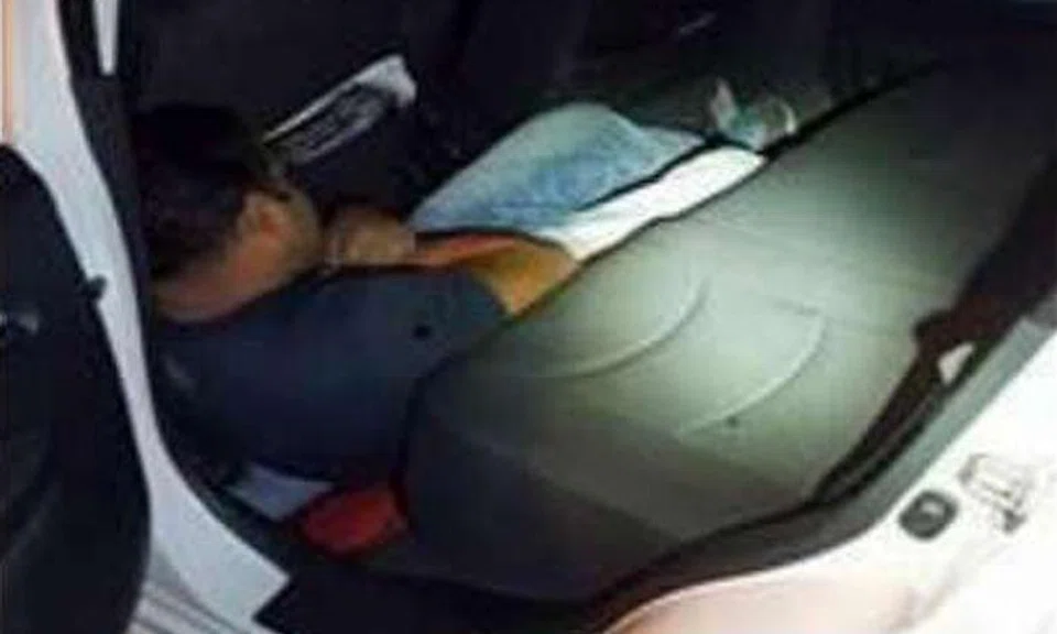 Bangladeshi overstayer Md Islam was found crouching on the floor of a Malaysia-registered car's rear passenger seat at Woodlands Checkpoint on Feb 14, 2016. PHOTO: ICA