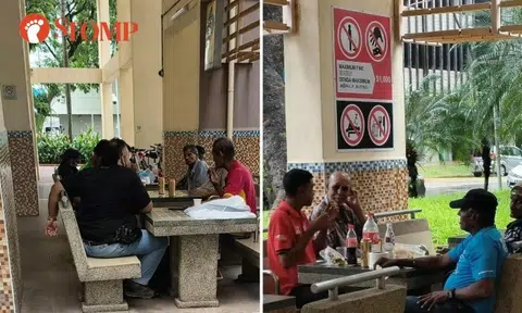 Men smoke and drink in Jalan Besar residents' corner under signs prohibiting smoking and drinking