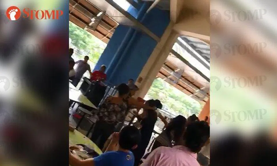 Two women shout and exchange blows in fight at Tekka Centre