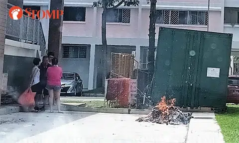Family burn offerings in carpark in Hougang housing estate, ashes fly onto vehicles and into homes