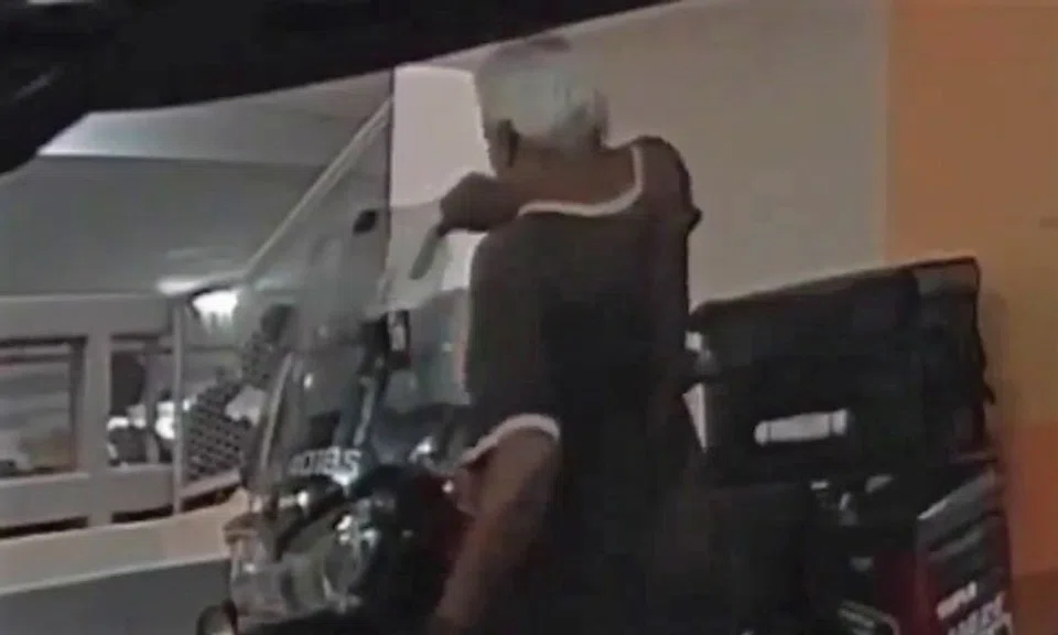 A man was caught on video taking a cash card out of a motorcycle in-vehicle unit (IU) in a Queenstown multi-storey carpark.