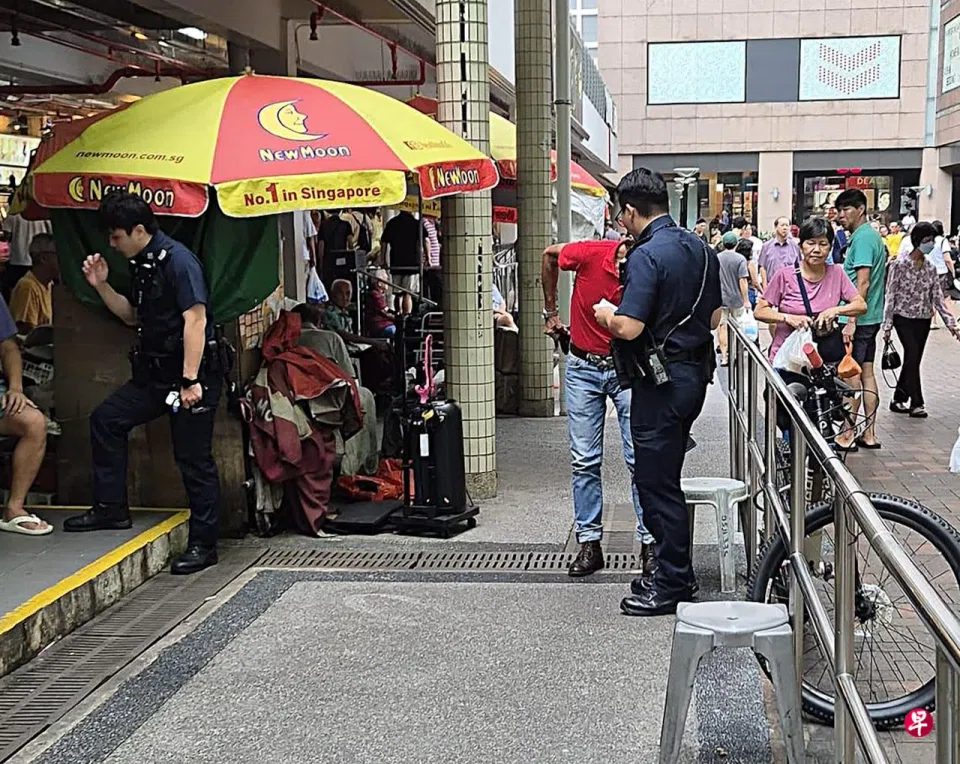 The man and his family was eating at the food centre when a man sitting at a nearby table lit a cigarette.