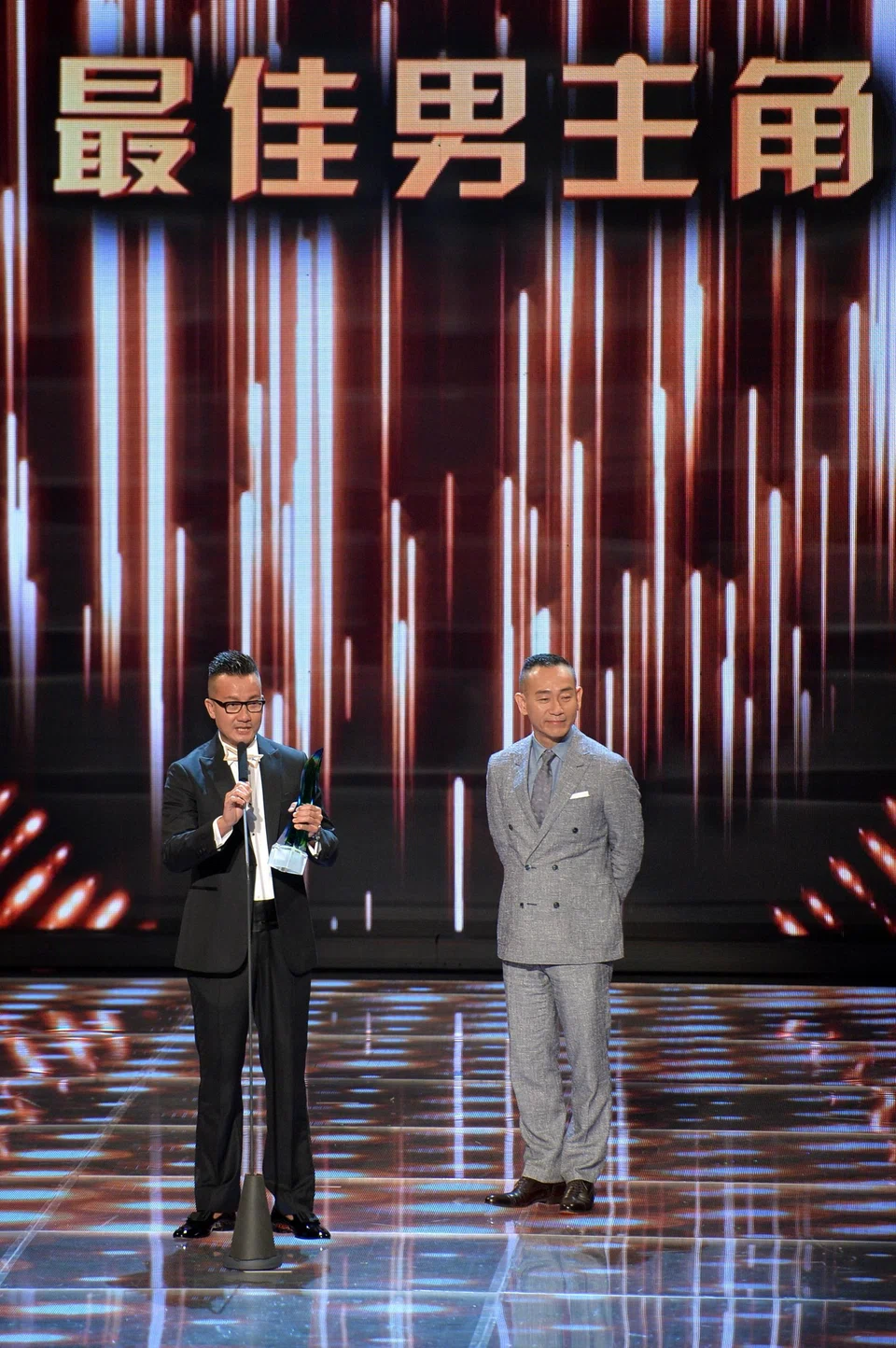 Chen (left) winning Best Actor in 2017, next to the award’s presenter, Hong Kong actor Bowie Lam (right).