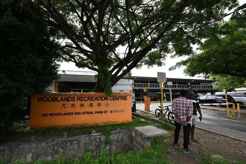 Migrant workers chatting at the entrance of Woodlands Recreation Centre on Jan 26.