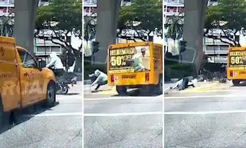 A dashcam video posted on Roads.sg shows the woman and a man riding their e-bikes across the junction even though the traffic light was not in their favour.
