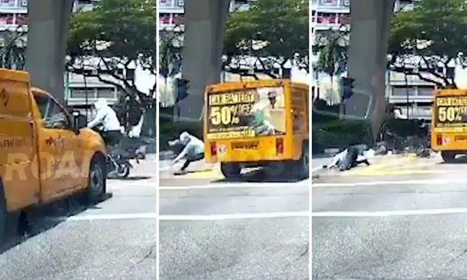A dashcam video posted on Roads.sg shows the woman and a man riding their e-bikes across the junction even though the traffic light was not in their favour.