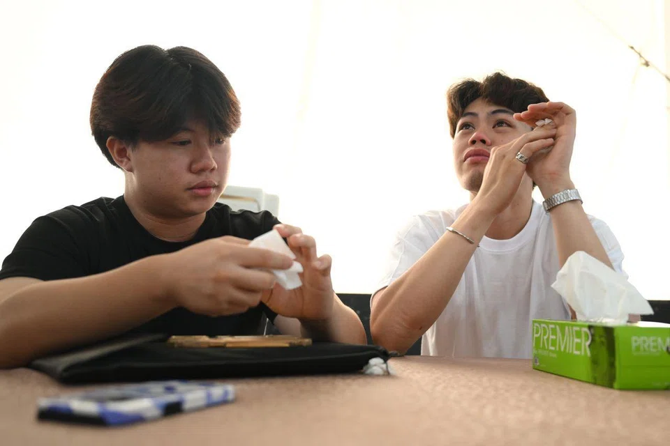 Mr Sir Ludvig Kong (left) and Mr Pombuena Kevin Paul Famacion at the wake of Ms Queenie Leong in Yishun Street 11 on Aug 4. ST PHOTO: SHINTARO TAY