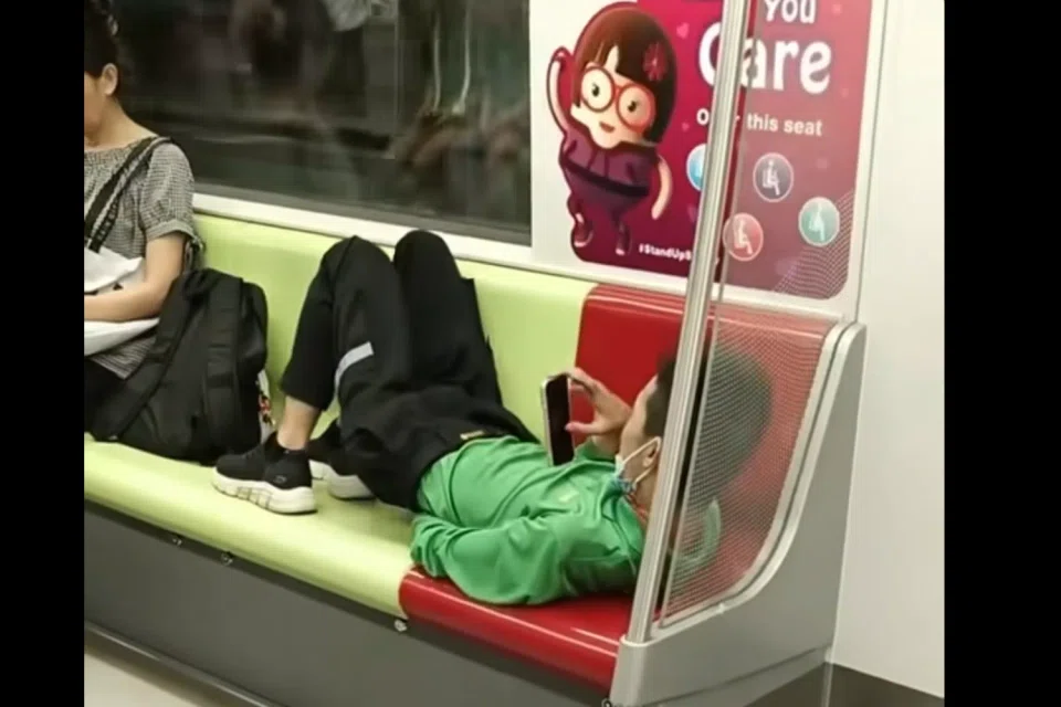 The passengers around the man appeared oblivious to his actions. 