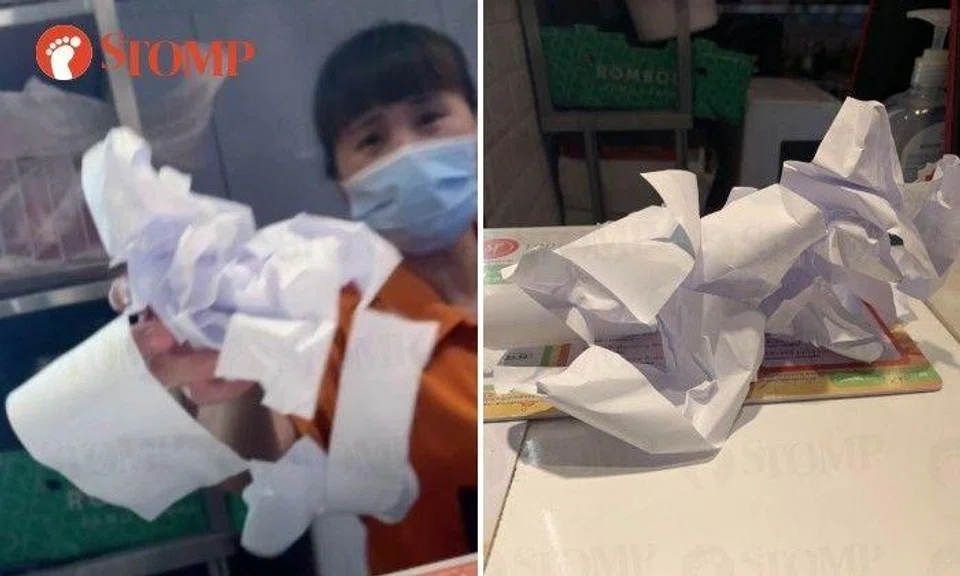 The Stomper shared a video showing a woman at the stall bending down behind the counter to pick up a mess of crumpled paper and placed it on the counter top.