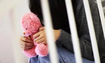 Girl holding teddy bear