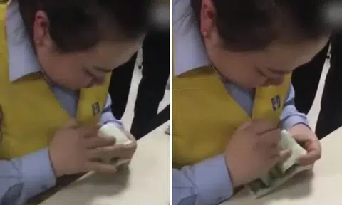 Look at those fingers go! Chinese woman counts money faster than cash-counting machine