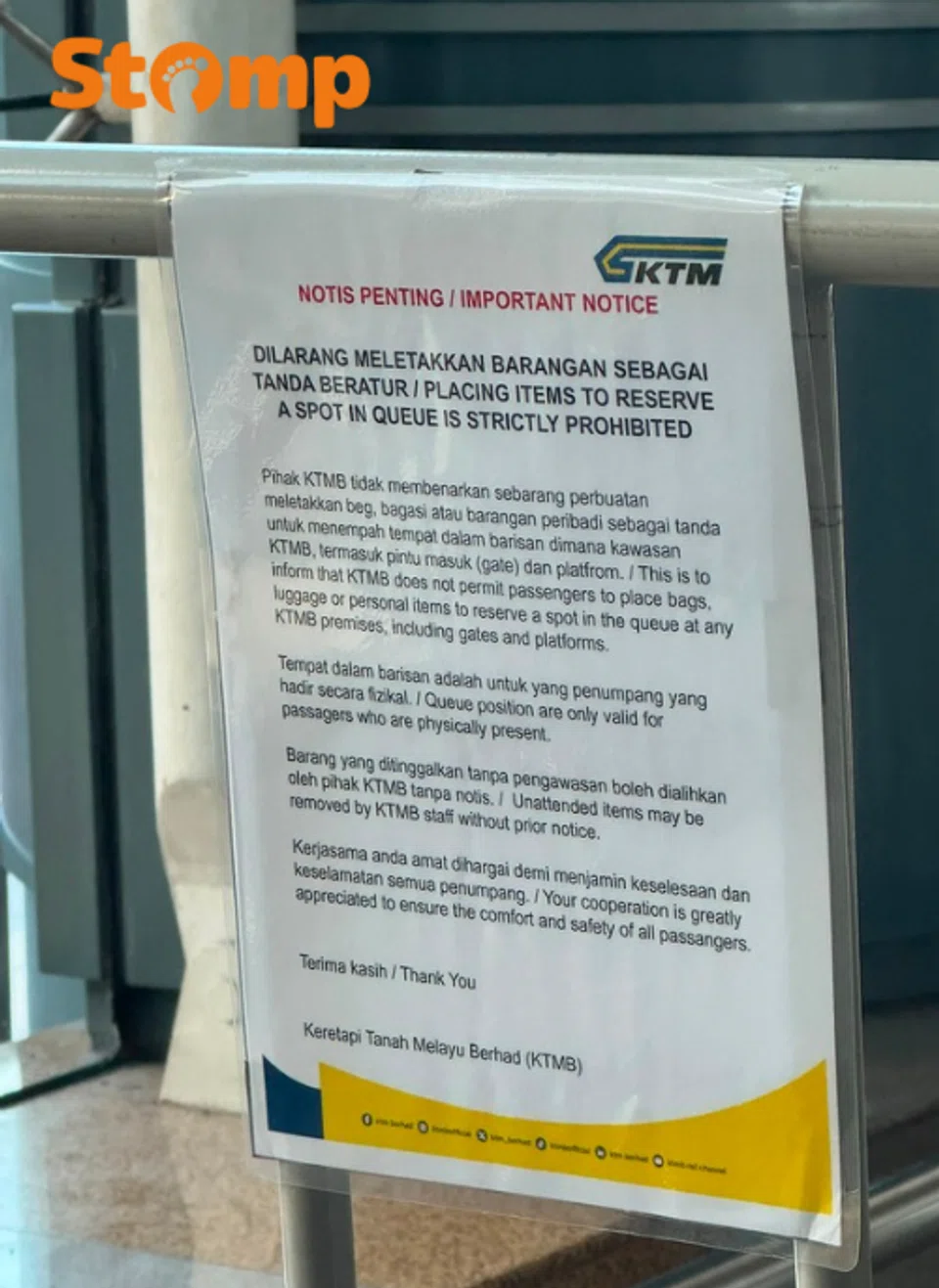KTMB sign warning travellers against reserving their spots in the queue for the train