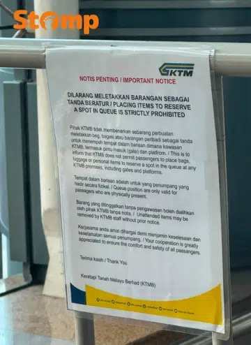 KTMB sign warning travellers against reserving their spots in the queue for the train