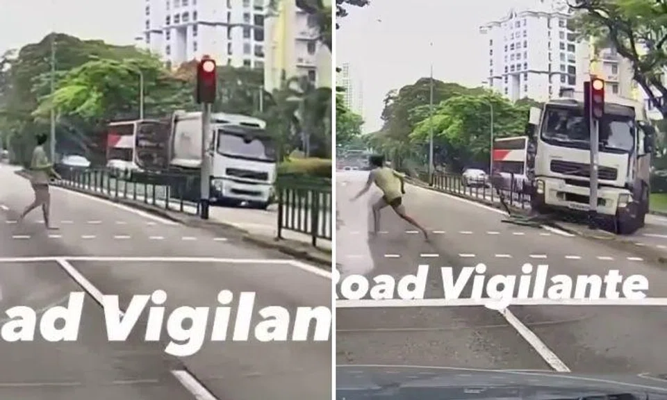 In a clip from dashcam footage posted on Facebook page SG Road Vigilante, vehicles can be seen stopping at a red light and a woman starts to cross.