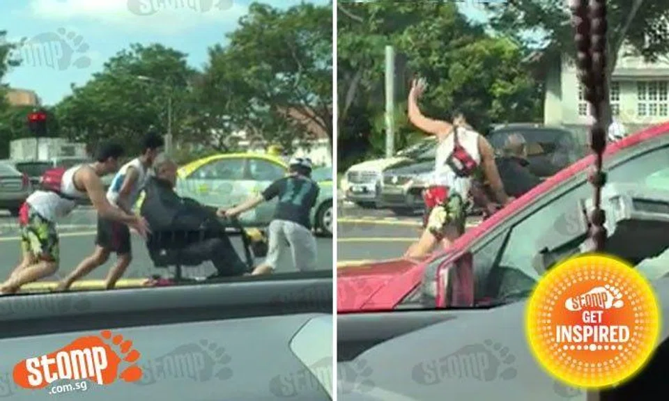 Awesome students help to push man in broken motorised wheelchair across pedestrian crossing at Bishan St 14