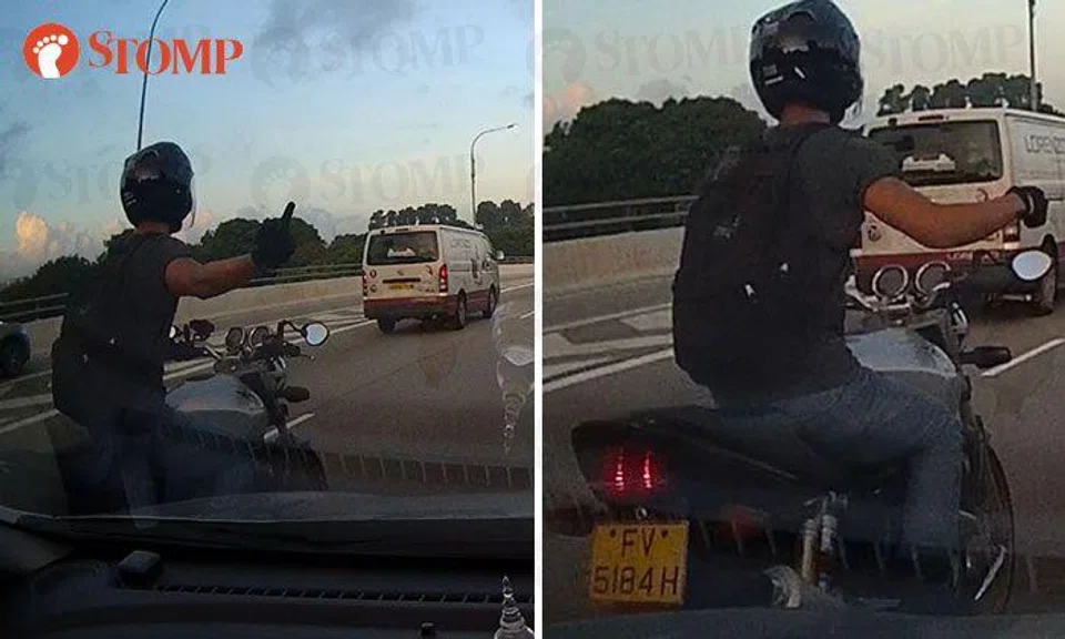 Motorcyclist points middle finger at driver who filtered into his lane