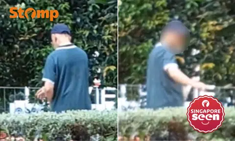 Man scatters ‘food’ around bushes while smoking outside Sengkang Grand Mall restaurant