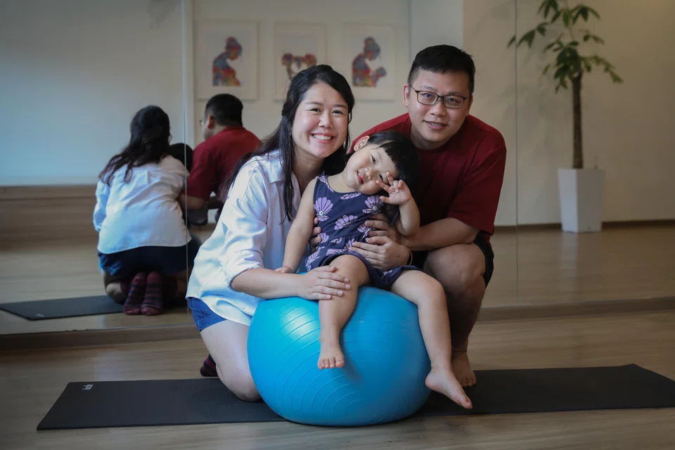 Yoga teacher Ho Kin Ing (left) relied on her husband Tan Peng Yong to support her through postpartum depression. They have three daughters, including three-year-old Beatrice.