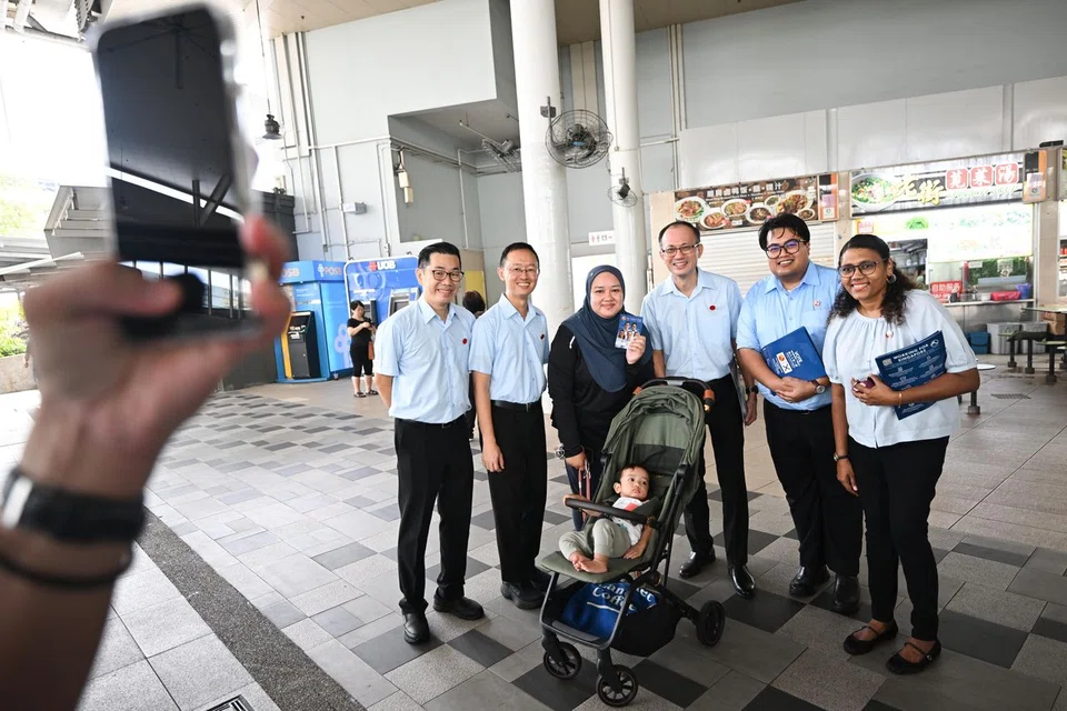 WP's East Coast team (from left) Mr Jasper Kuan, Mr Nathaniel Koh, Mr Yee Jenn Jong, Mr Sufyan Mikhail Putra and Ms Paris V. Parameswari meeting residents during a walkabout at Bedok Interchange Hawker Centre on April 24.