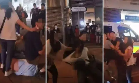 Videos show a man in a light blue T-shirt lying on his side as two men pinned him to the ground. SCREENGRAB: HK01/YOUTUBE