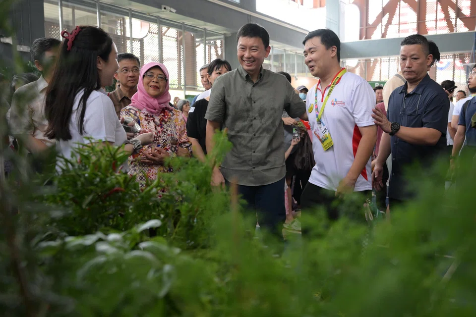 Minister for National Development Chee Hong Tat (centre) said the planning of the new town gave residents opportunities to share ideas for the estate before moving in. With him is Mdm Halimah Yacob (left), patron of the Friends of Our Heartlands network.