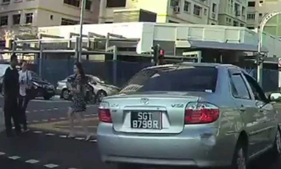 Pedestrians forced to jump out of the way of reckless driver who beat red light