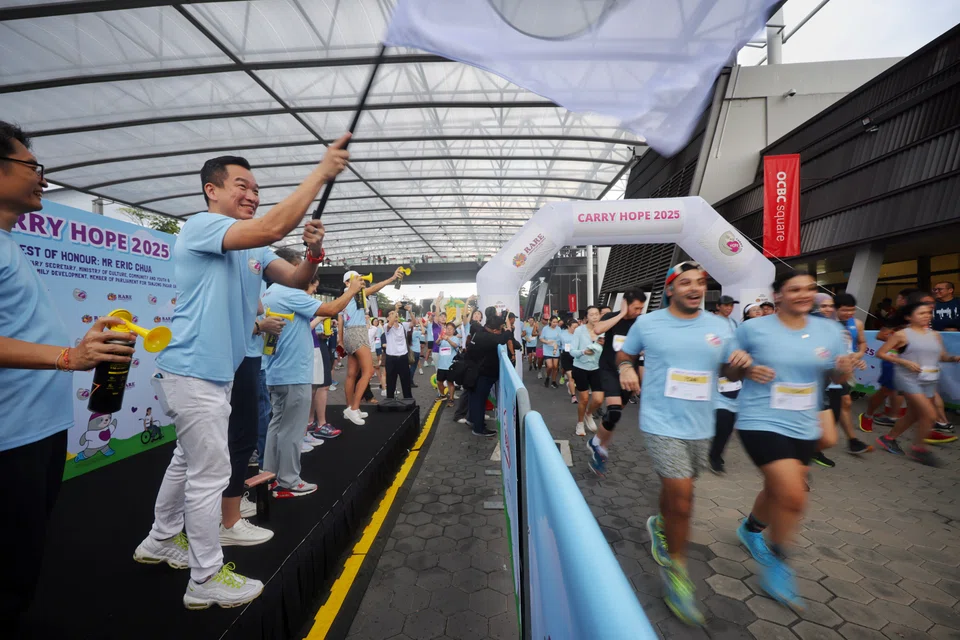Senior Parliamentary Secretary, Ministry of Culture, Community and Youth & Ministry of Social and Family Development Eric Chua flagging off the Carry Hope Walk and Run at Singapore Sports Hub on Feb 22.