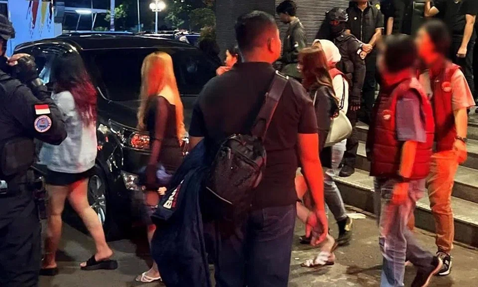 Suspected drug offenders being arrested in a joint anti-drug operation in Batam, Indonesia