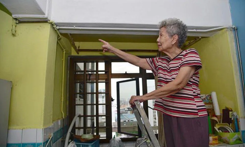 Madam Gan Leng Neo pointing to the work that was done on her ceiling. Photo: The New Paper