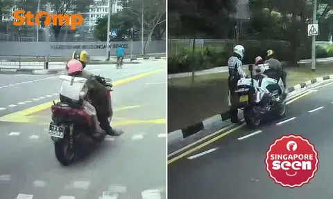 motorcyclist riding with young child as pillion rider stopped by TP in Punggol