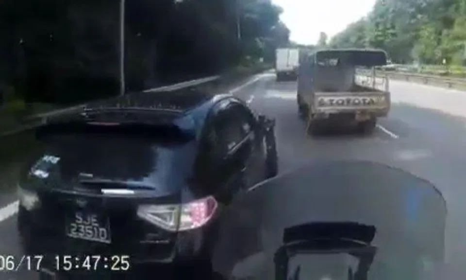 Driver of Subaru SJE2351D gets dangerously close to motorcyclist by overtaking from left -- then speeds away