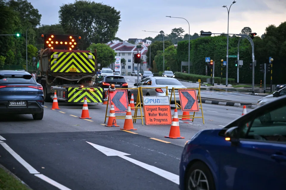 When ST arrived at the condo around 5.30pm, two trucks and a lorry were parked on a lane at the road junction, which was cordoned off with safety cones. ST PHOTO: ARIFFIN JAMAR