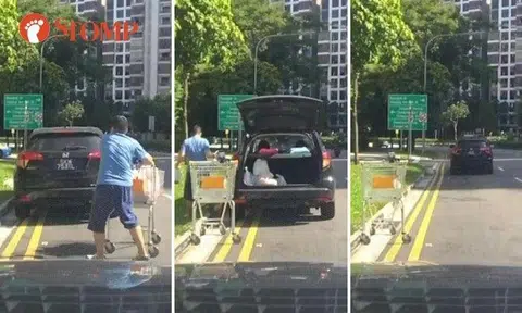 Motorist loads car parked illegally on double yellow lines, leaves trolley behind on roadside in Sengkang