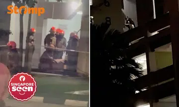 Woman on ledge of multi-storey carpark in Choa Chu Kang