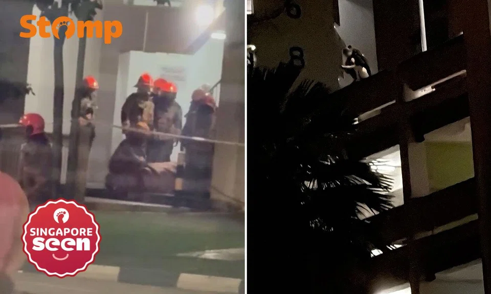Woman on ledge of multi-storey carpark in Choa Chu Kang