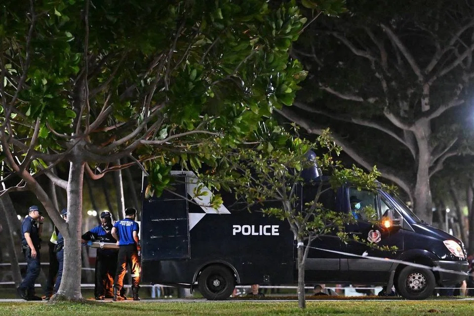 The boy's body being loaded into a police van at 12.42am on Aug 31. ST PHOTO: LIM YAOHUI