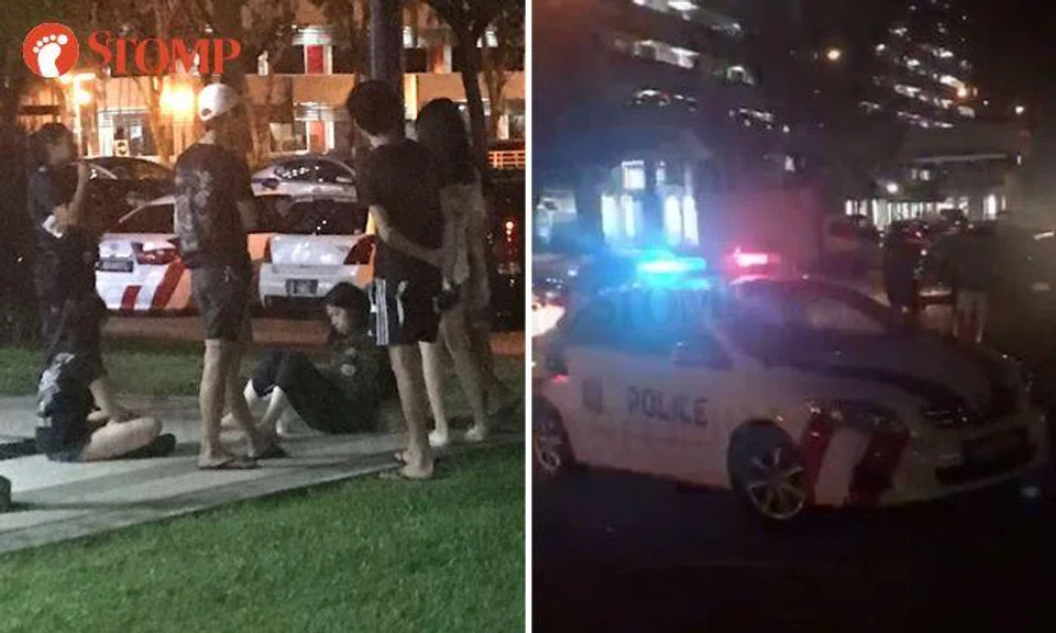 A group of youths at the void deck of Block 201 (left) were arguing with another group of youths (right)