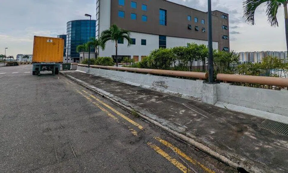 The driver is believed to have lost control as the lorry went over a curb and hit the railing on the side wall of the multi-storey carpark. Photo: Lianhe Zaobao