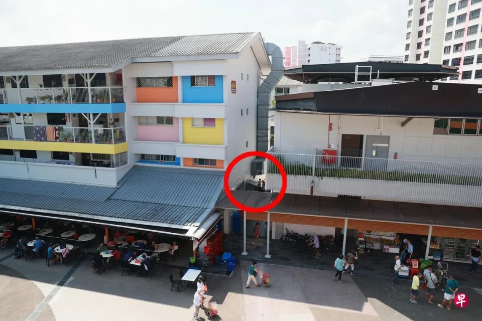 The alley where men gather to gamble with dice between Block 493 and Block 494, Jurong West Street 41
