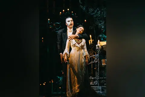 Grace Roberts (foreground) as Christine in The Phantom Of The Opera musical, with Jonathan Roxmouth as the Phantom. 