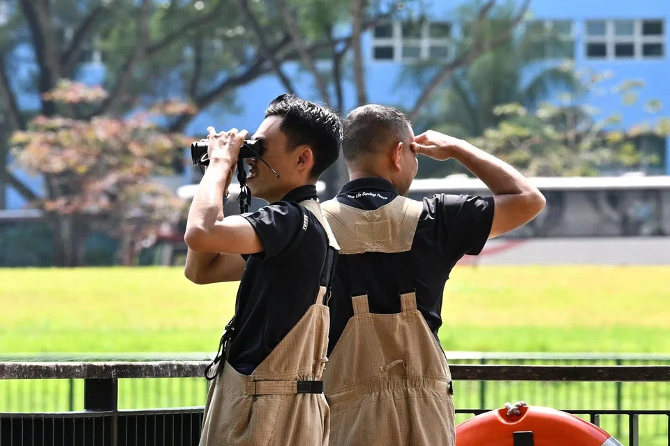 SCDF personnel searching for Daniel near Block 8B Upper Boon Keng Road at 3.26pm on Feb 26. ST PHOTO: LIM YAOHUI