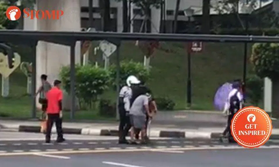 Kind TP officer stops to help elderly woman cross road in Yishun