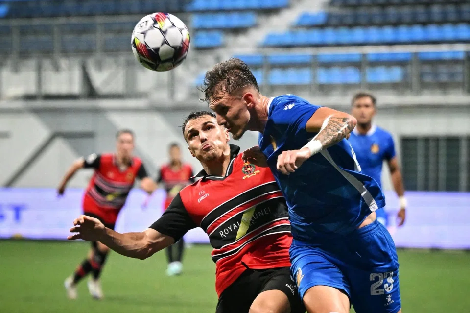 Hougang United's Daniel Henrique (right) winning a header against Brunei DPMM's Miguel Oliveira.