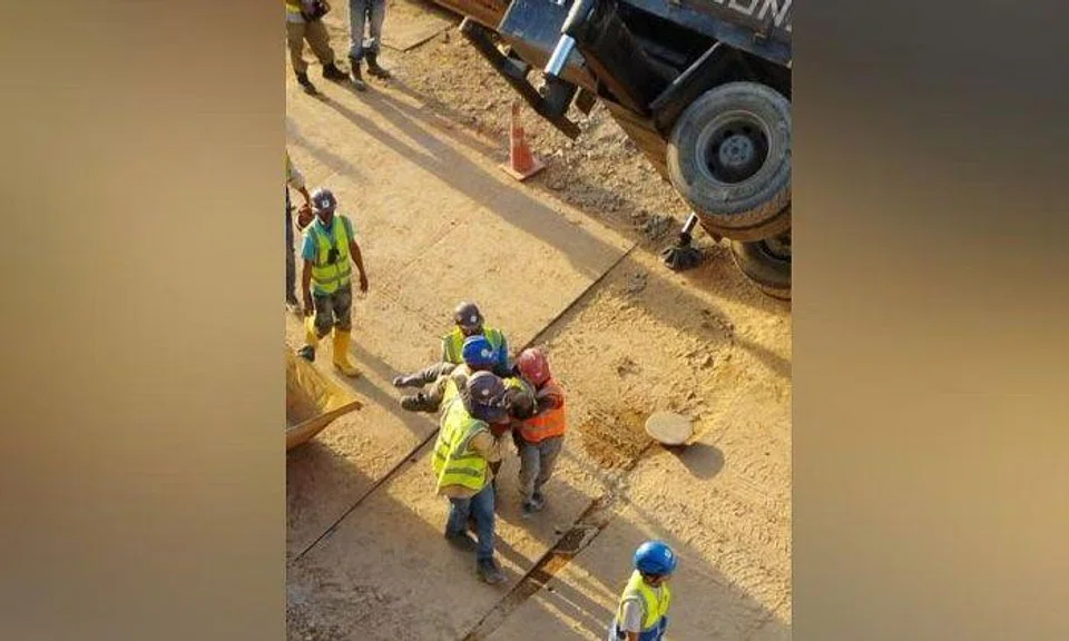 The worker was struck by a concrete bucket, fracturing his ankle and cutting his hand. PHOTO: ST READER