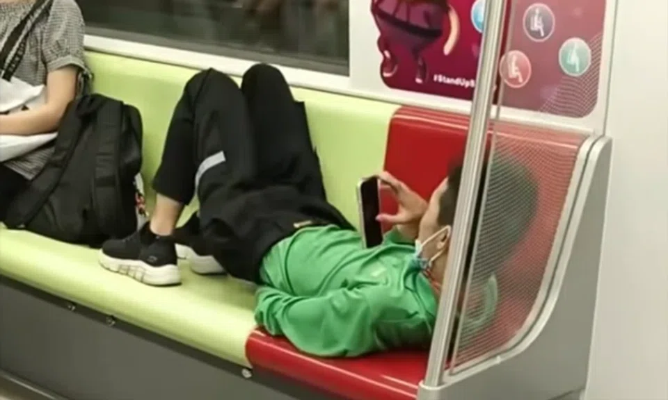 The passengers around the man appeared oblivious to his actions.