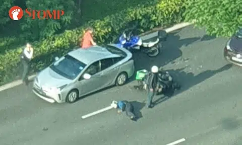 Motorcyclist lies on road, gets taken to hospital after accident with car along PIE